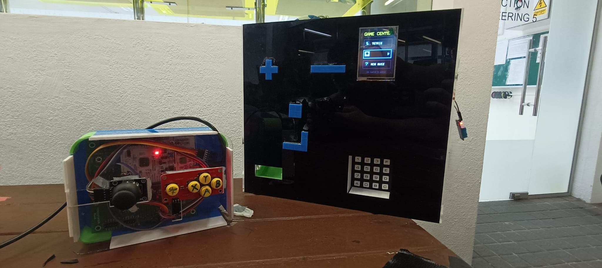 Microcontroller game console with a handheld controller, display, and keypad
